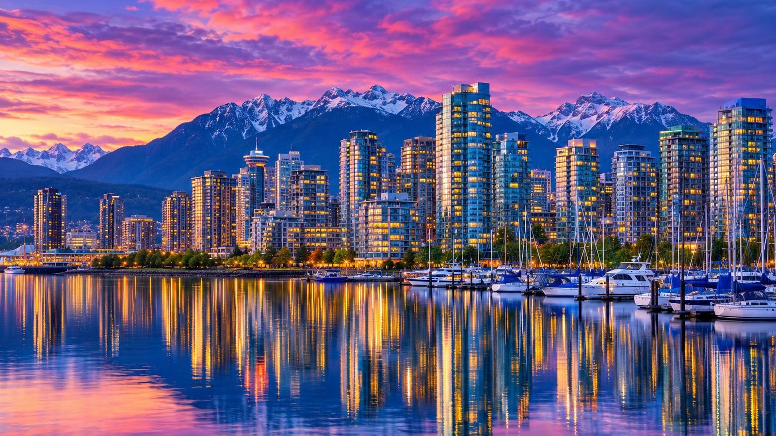 The Vancouver skyline and Coal Harbour at blue hour with the snow-capped North Shore Mountains behind